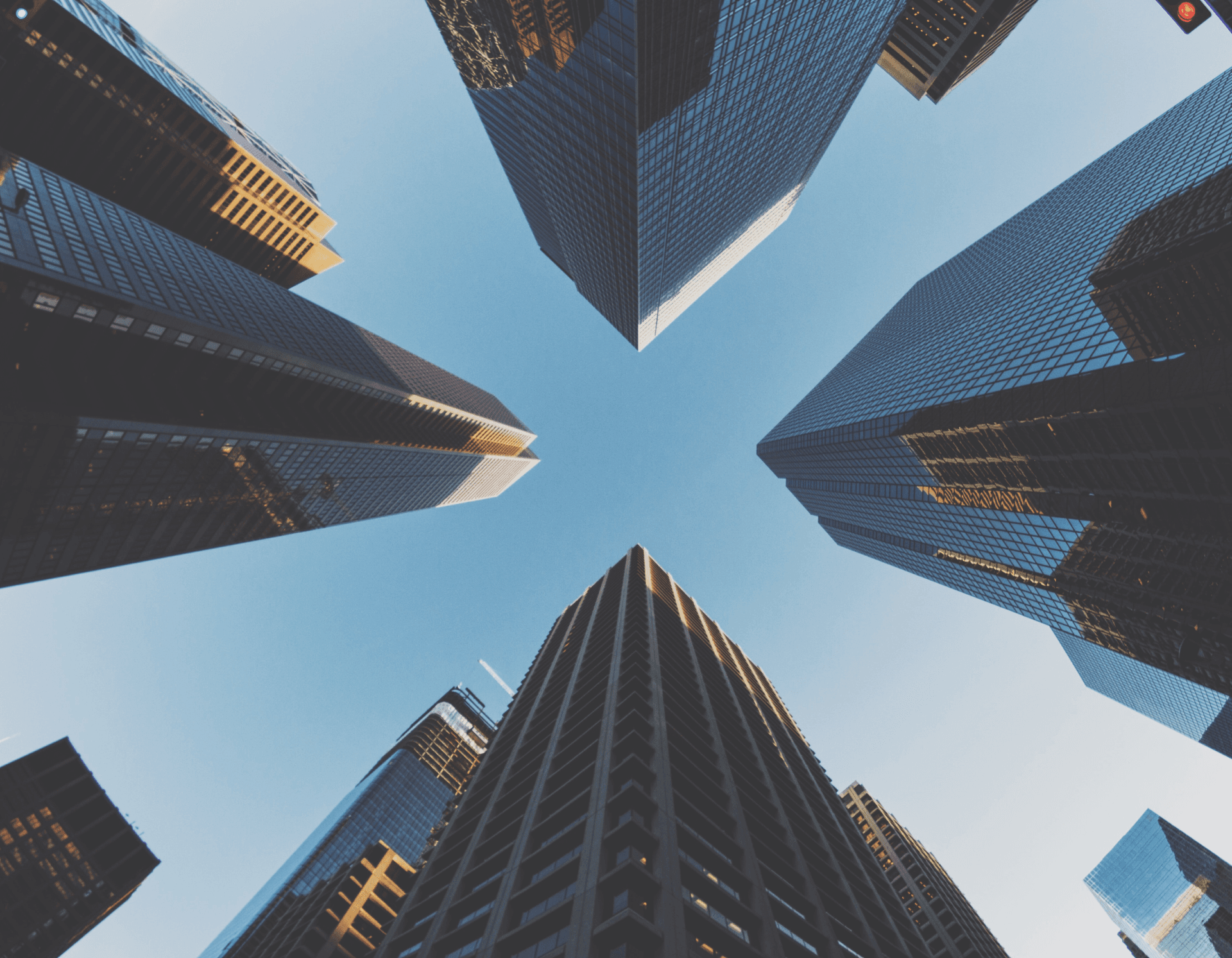 Skyscrapers towering over the city under a clear blue sky - a symbol of progress and growth.